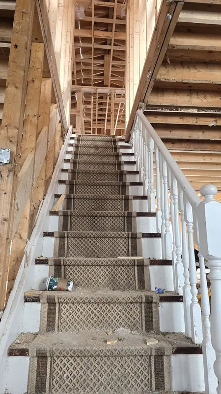 Carpeted staircase renovation framing