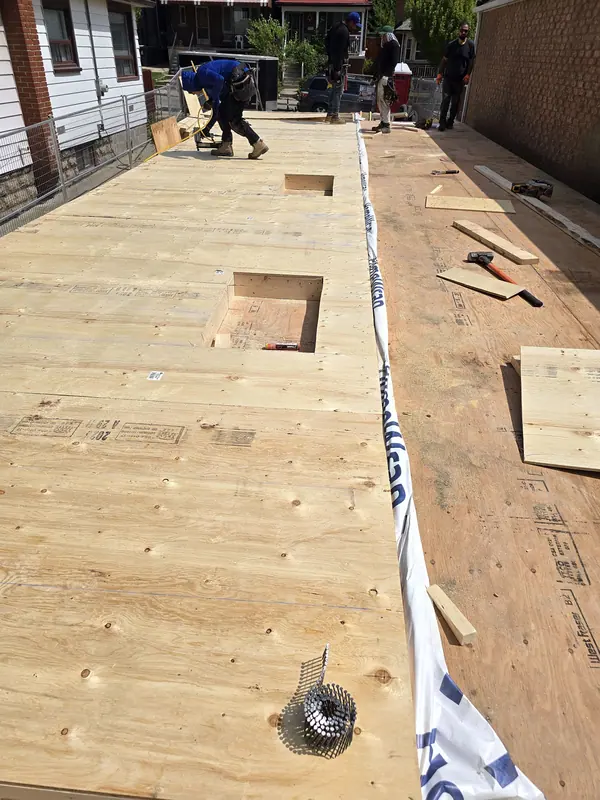 Plywood subfloor installation crew