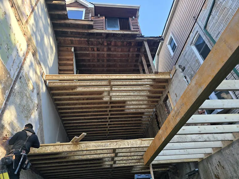 Rear extension floor joist framing worker
