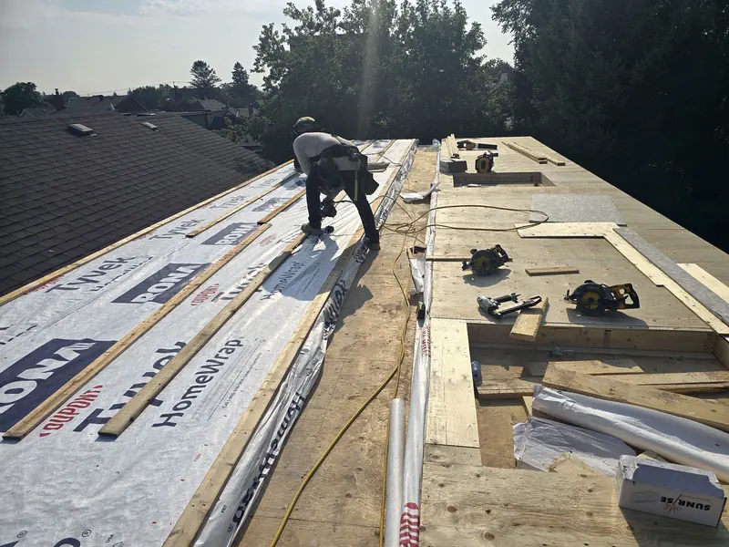Roof deck sheathing house wrap installation