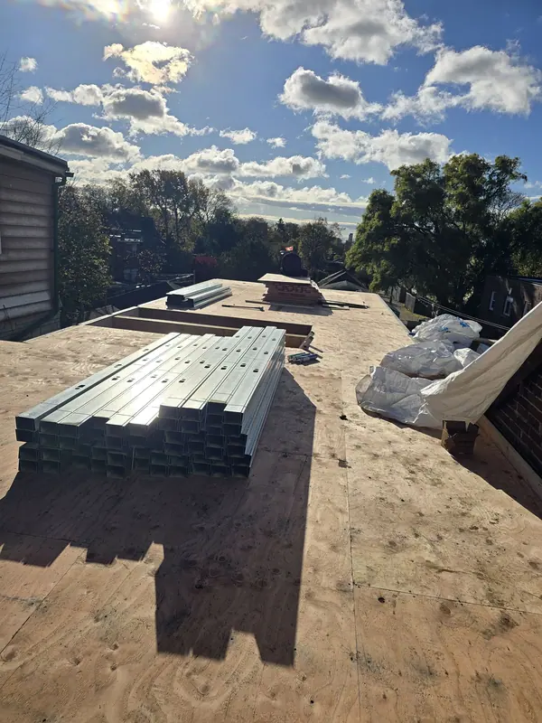 Steel studs staged on roof deck