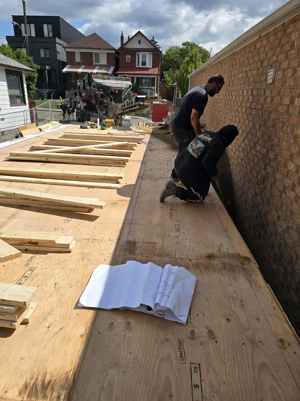 Subfloor sheathing worker installing plywood