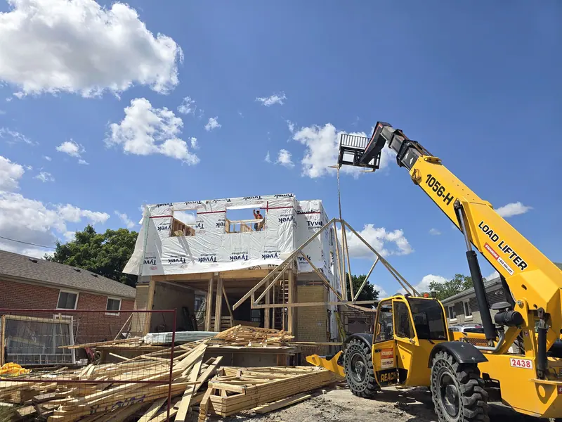 Telehandler lifting trusses home addition