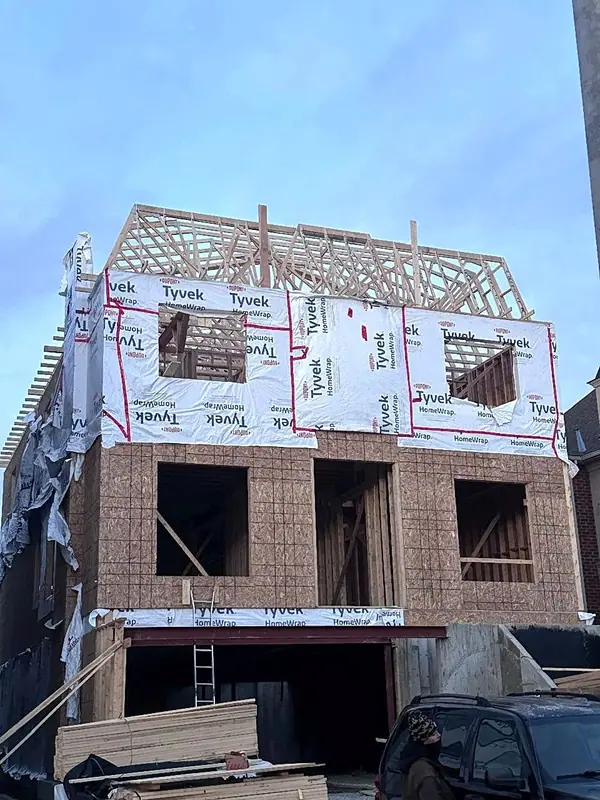 Three storey home framing roof trusses house wrap