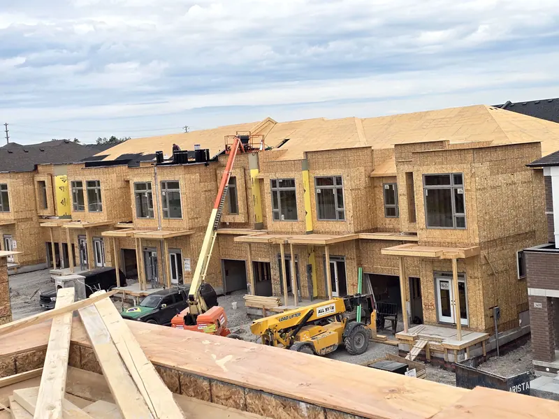 Townhouse row roof sheathing boom lift